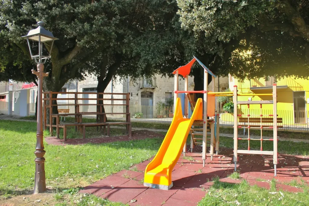 A colorful playground slide in a grassy park