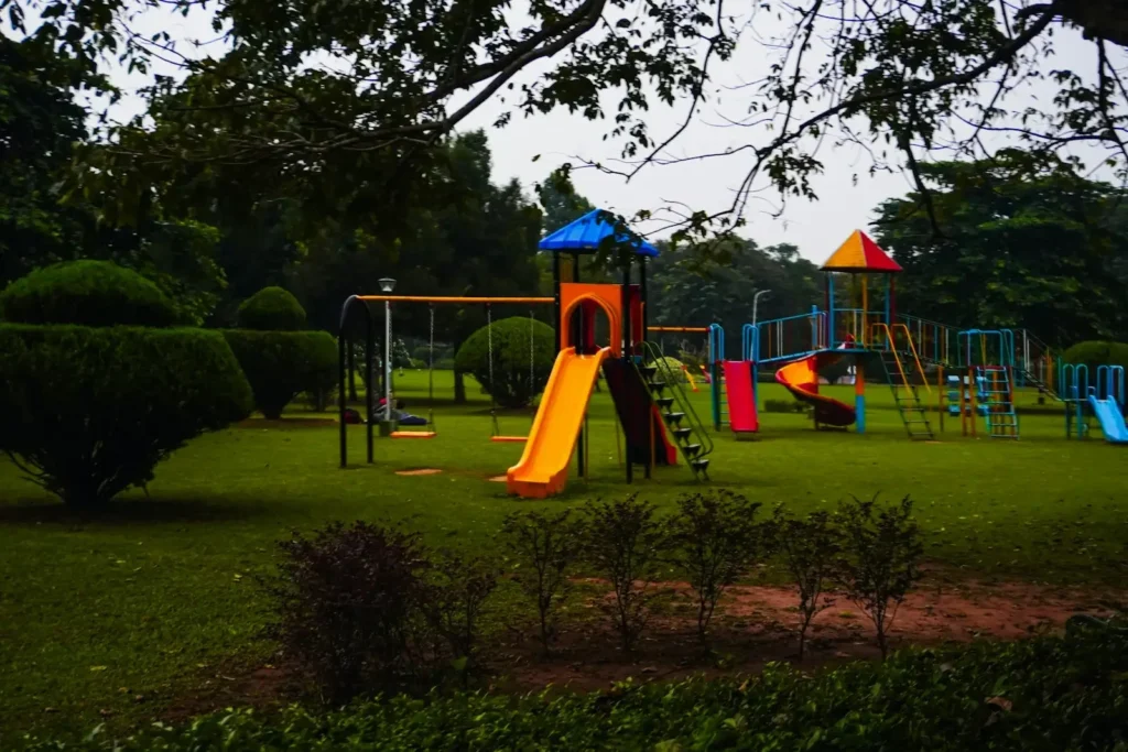 A colorful playground with slides and swings in a park